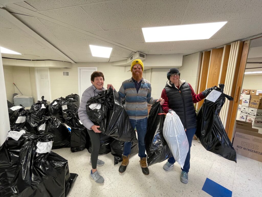 Grace Bender (CC Board), Ray Stokes (Volunteer) and Anastasia Crosswhite (CC Board) with Bags of Gifts