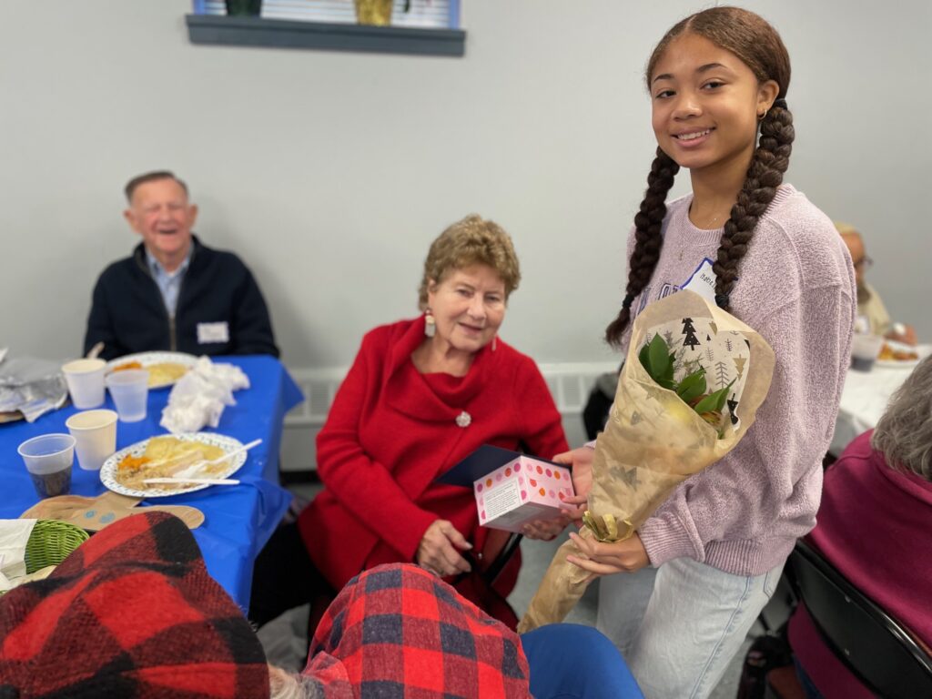 Eileen O'Leary receiving her Birthday Delivery at the December Luncheon