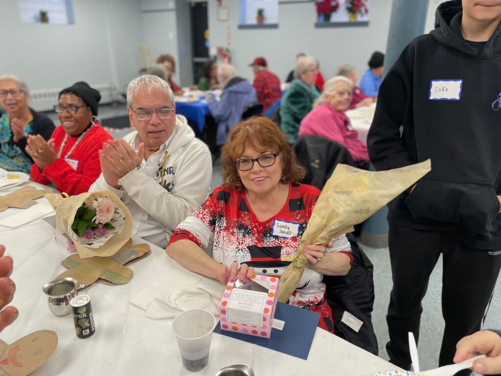 Sandy Small receiving her Birthday Delivery at the December Luncheon