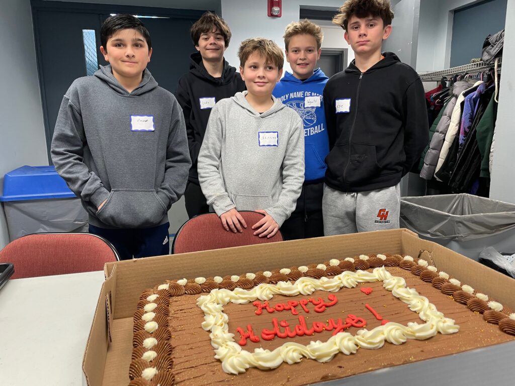 Students preparing to serve Baked by Susan Cake at December Luncheon